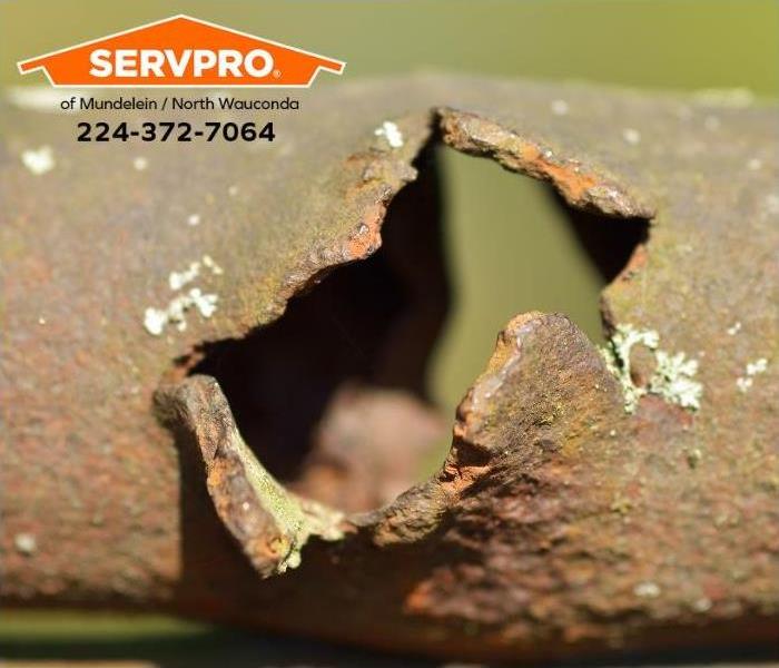 A closeup of a corroded pipe is shown.